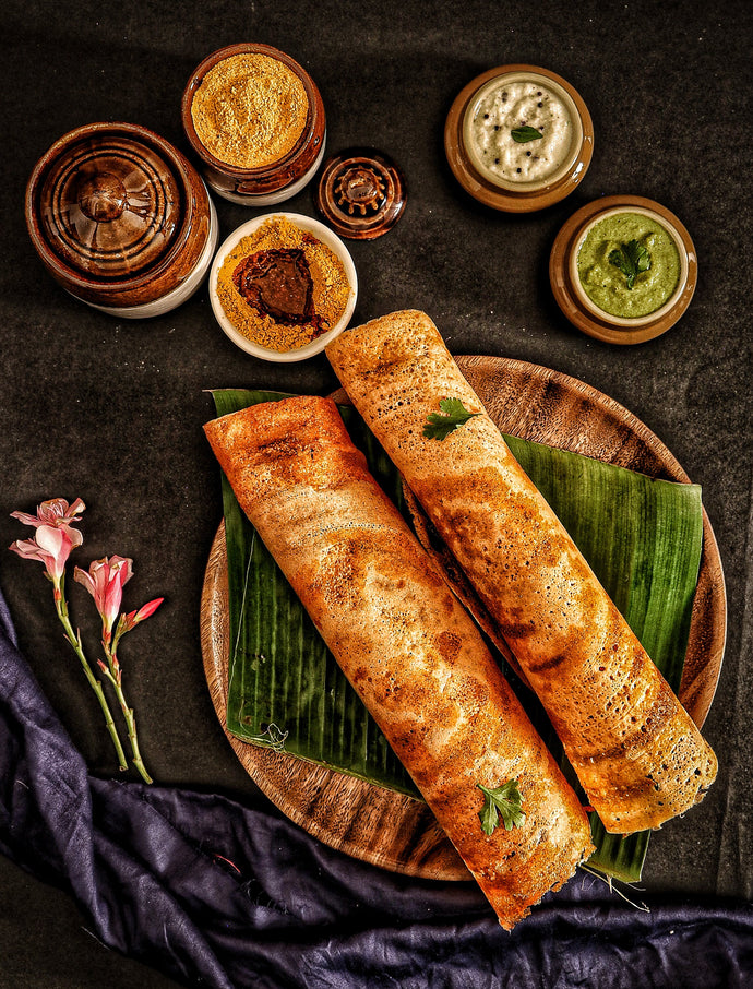 Delicious crispy dosa and chutneys served on banana leaf